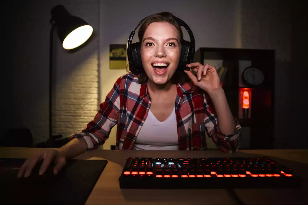 Women looking at computer screen with headphones on
