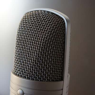 Close-up of a microphone, symbolizing teambuilding activities such as group karaoke or public speaking workshops, perfect for HR professionals planning engaging corporate events.